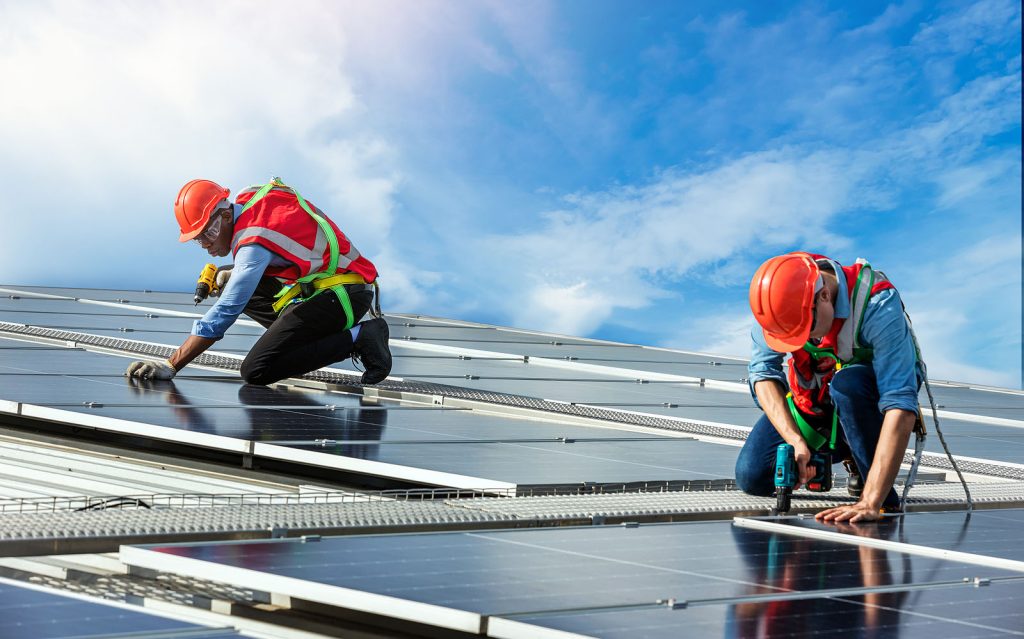 Engineer working setup solar panel at the roof top. engineer or